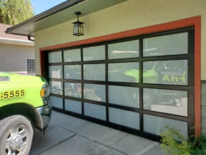 Modern residential garage door with frosted glass panels installed by professional garage door service technicians.