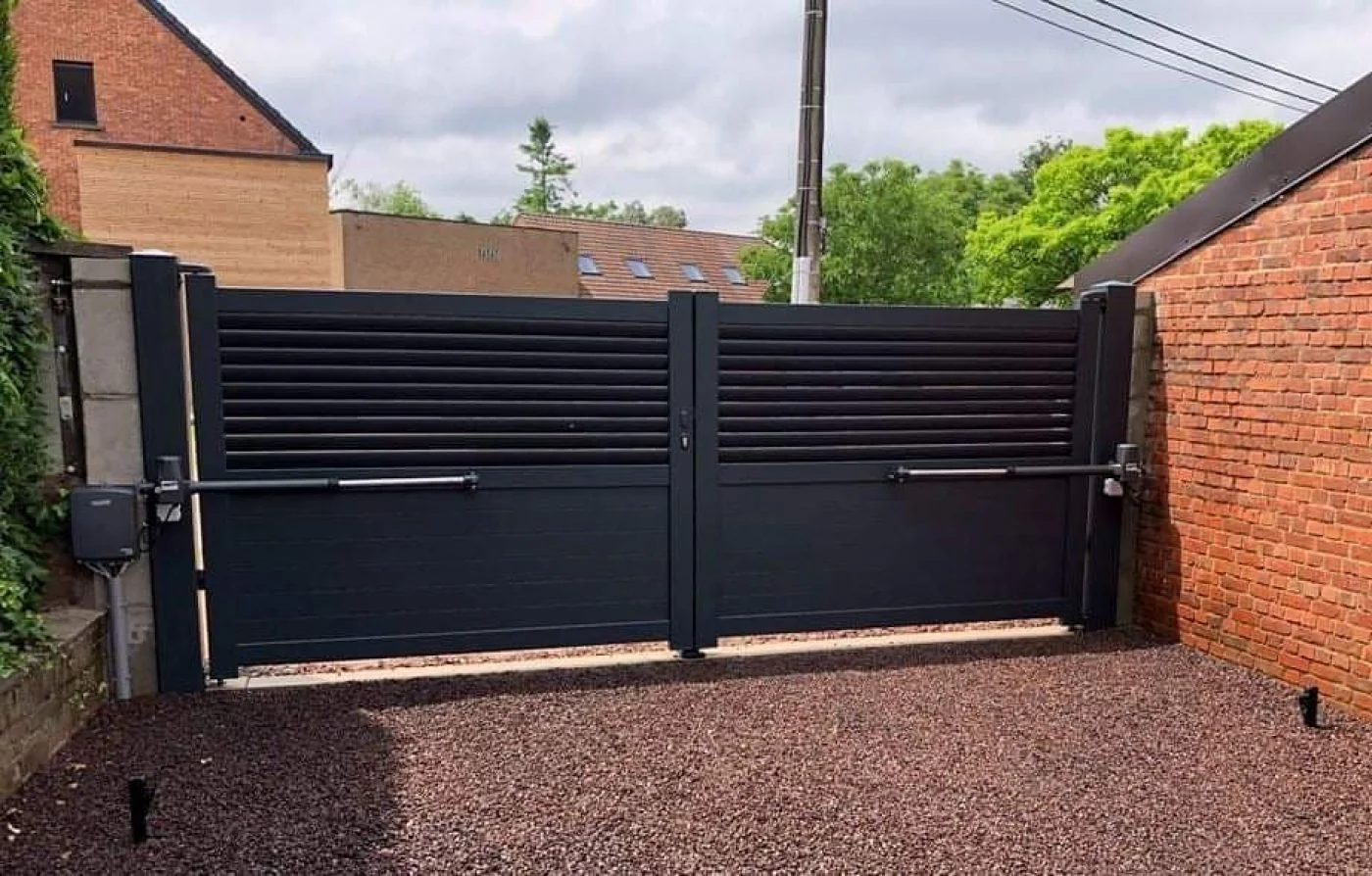 Black double gate with slatted upper panels and side pedestrian access.